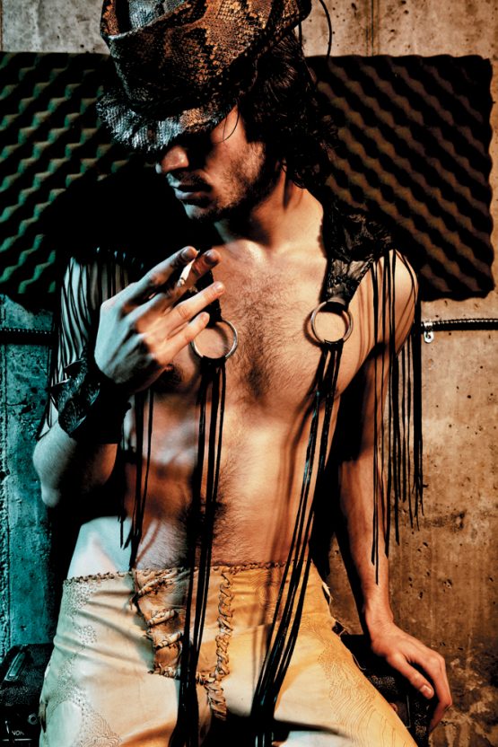 Male Model wears a Lost Art™ Python snakeskin hat, a Lost Art™ fox fur shawl with leather fringe and Lost Art™ leather pants
