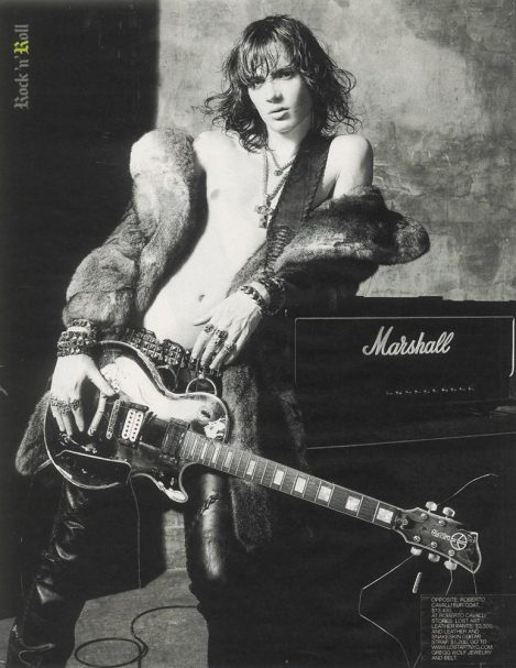Male Model wears custom-made Lost Art Leather Pants and a custom-made Lost Art Guitar Strap, image can be seen in the 2004 New York Times Mens Fashion Magazine