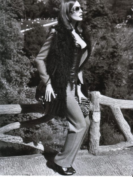 Model Daria Werbowy on a fence, wears a custom-made Lost Art Leather Corset by Jordan Betten in Vogue Paris Magazine circa 2006