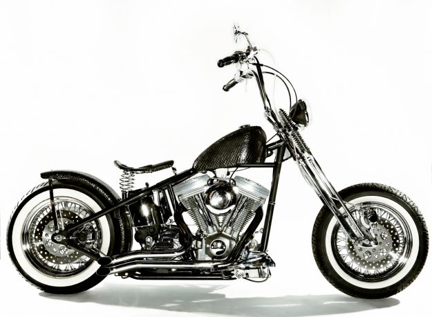 Side view of a Chopper Motorcycle with Custom-made Lost Art™ Anaconda snakeskin cover on the gas tank and fender, As well as Custom-made Lost Art™ leather covers for the handlebars and seat -Custom Leather for Motorcycles