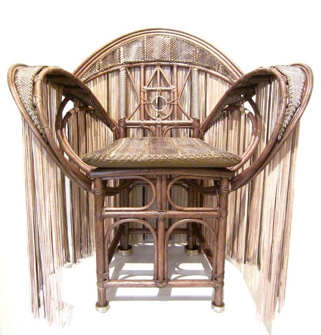 The Butterfly Chair - A Lost Art hand-made chair covered in cobra snakeskin and leather fringe with a cobra skin covered seat cushion and metallic silver rings leg tips
