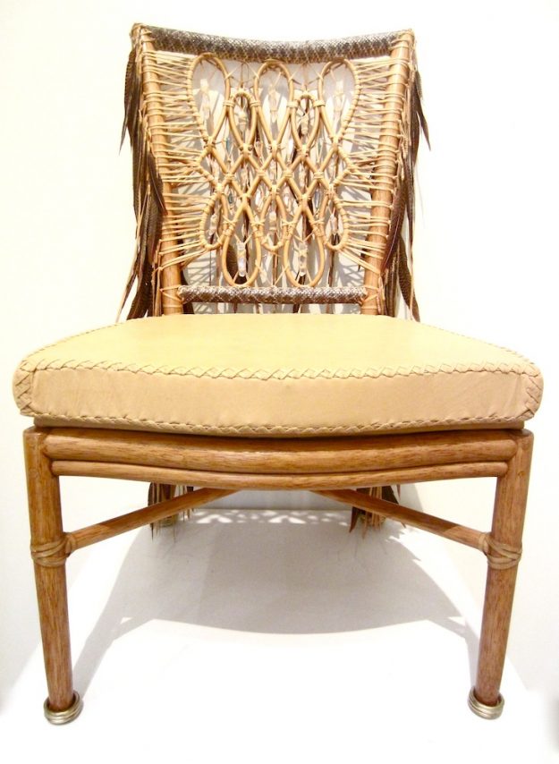 Lost Art hand-made chair covered in Crystal, Feather and rattlesnake details, along with a deerskin leather cushion and metallic silver rings leg tips